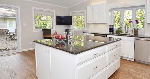 Finished white kitchen cabinets with dark countertops