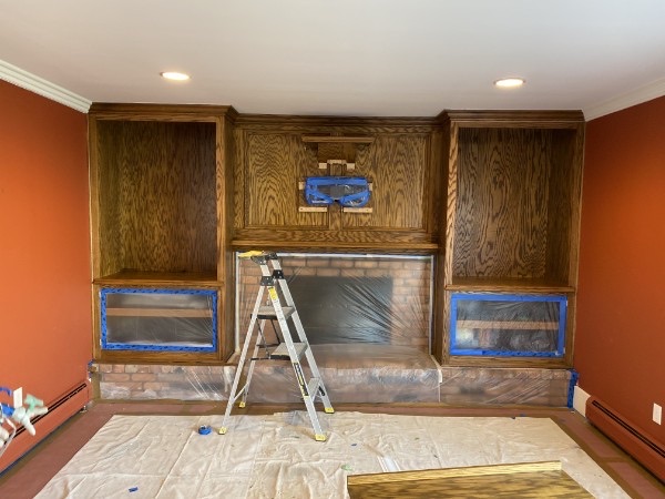 Fireplace, built-ins, floor, and openings masked before interior painting