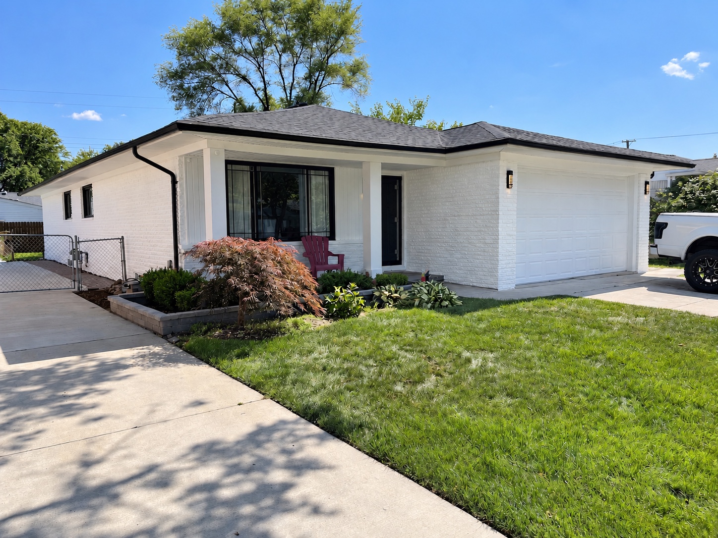 White painted brick exterior with black trim after exterior painting