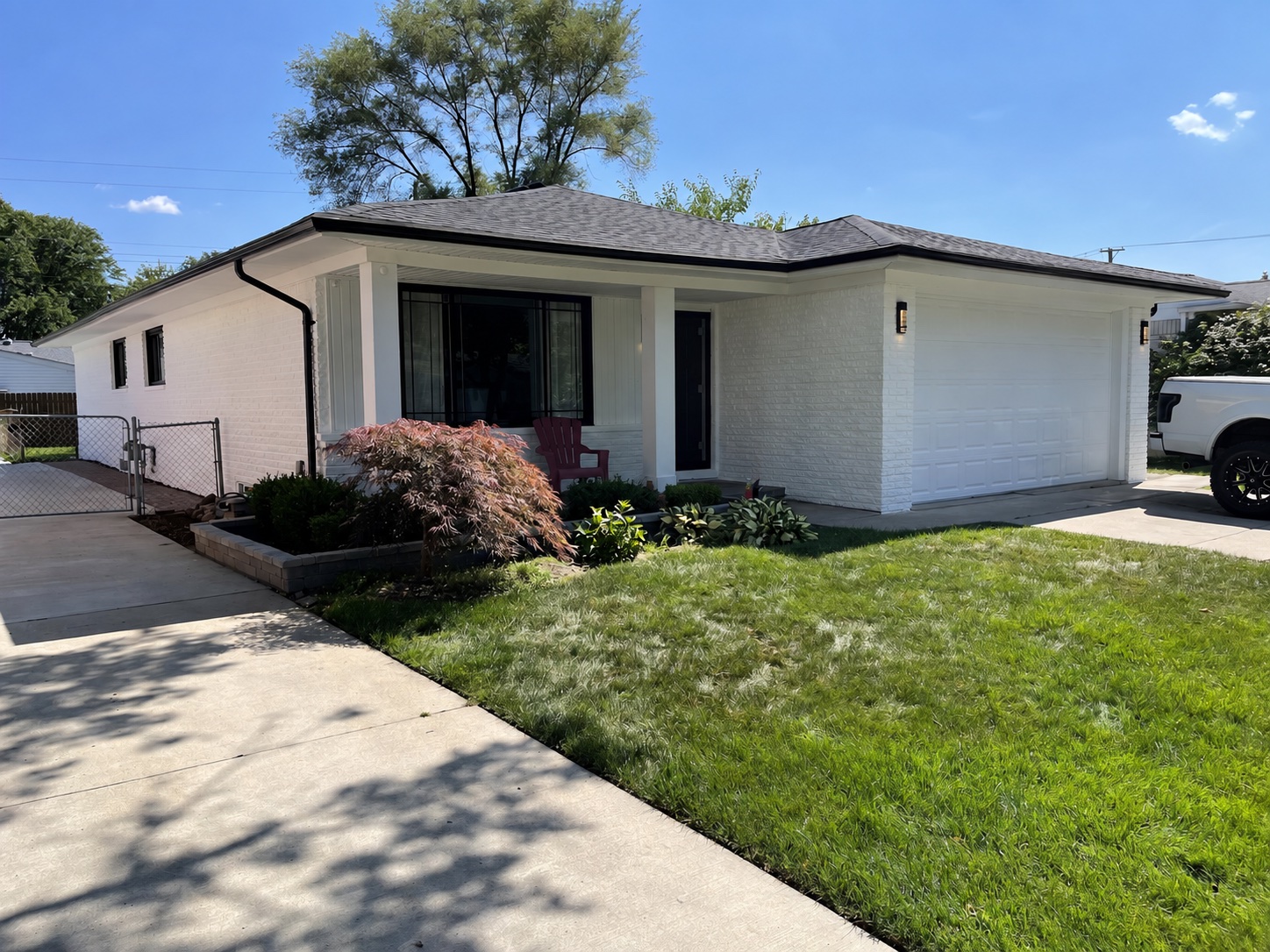 Finished white painted brick exterior with black trim on a Metro Detroit home